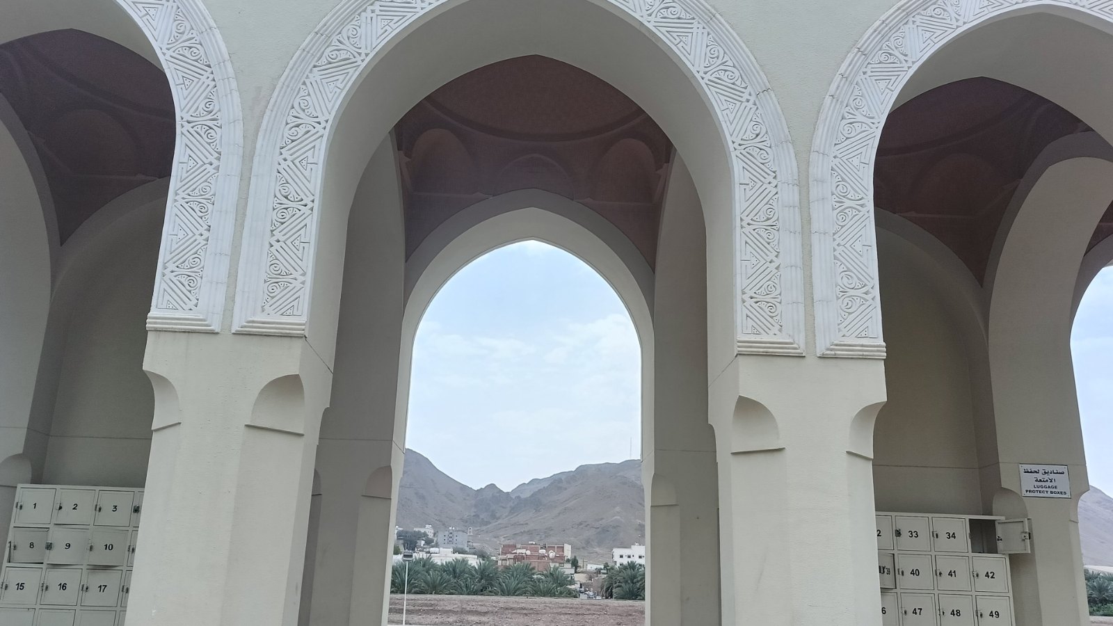Gerbang lengkung Masjid Zulhulaifah di Bir Ali dengan bukit di kejauhan