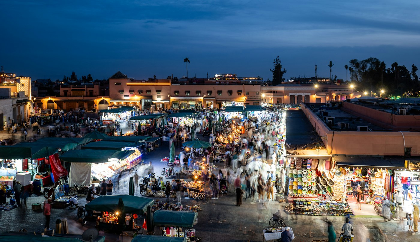 Gerai makanan dan orang ramai di dataran Marrakech selepas senja