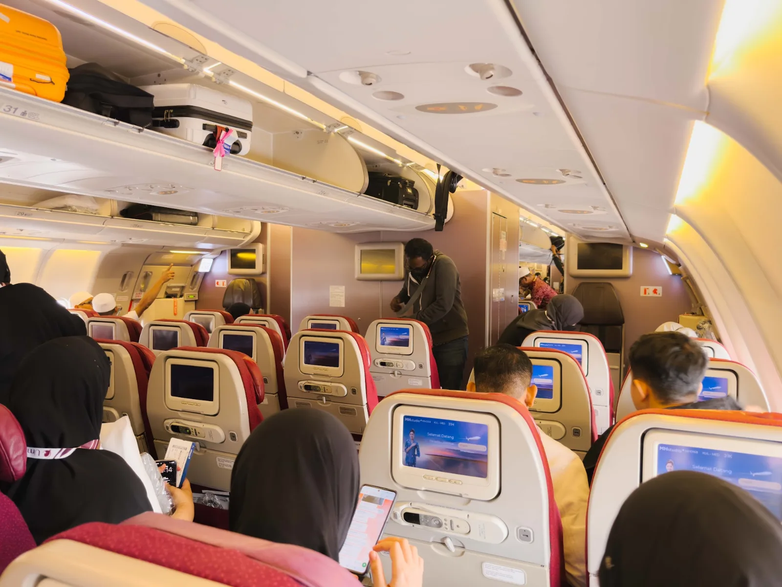 Kabin pesawat yang dipenuhi jemaah umrah dalam penerbangan ke Arab Saudi