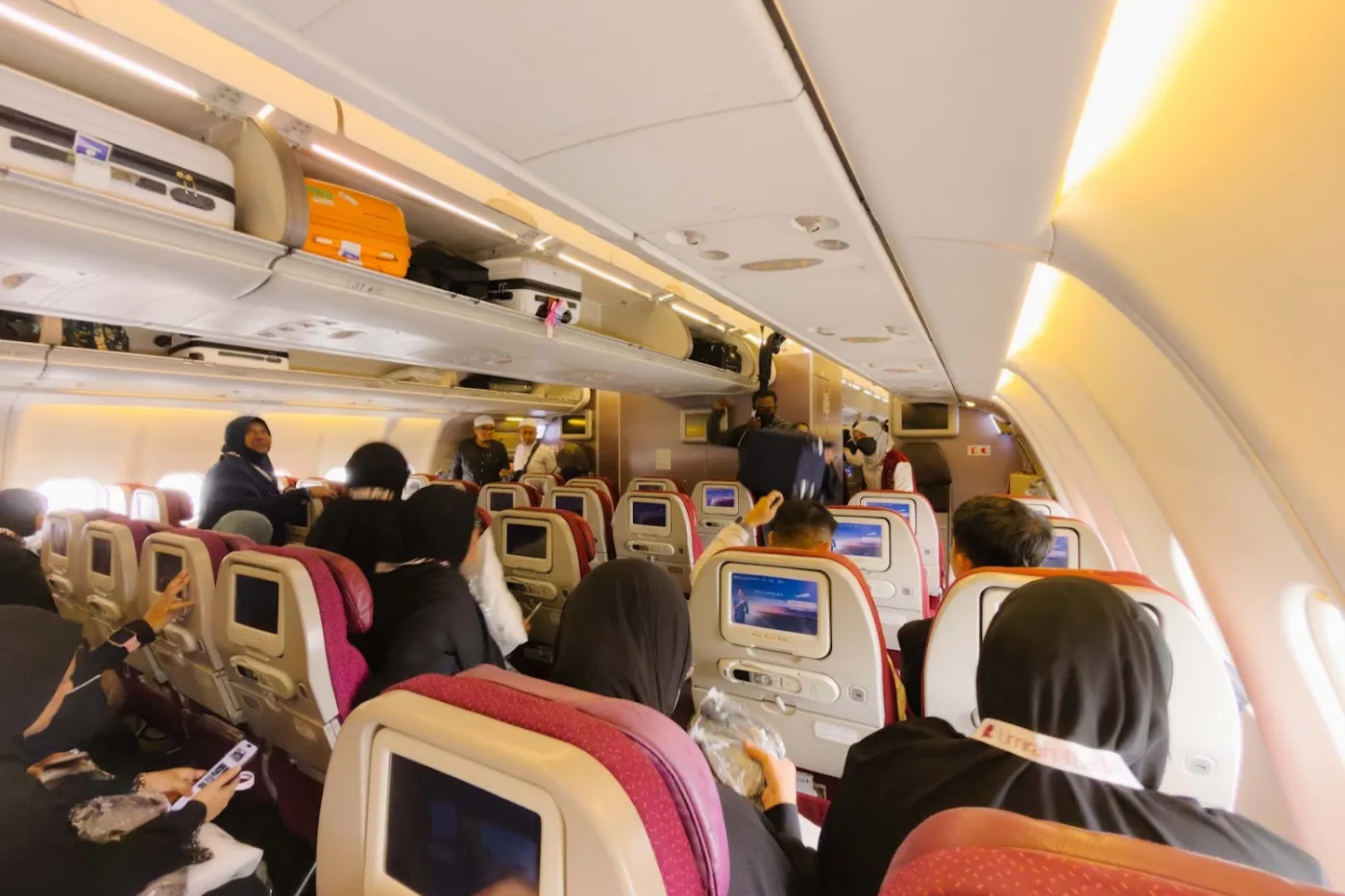 Jemaah umrah di dalam kabin pesawat menuju Tanah Suci