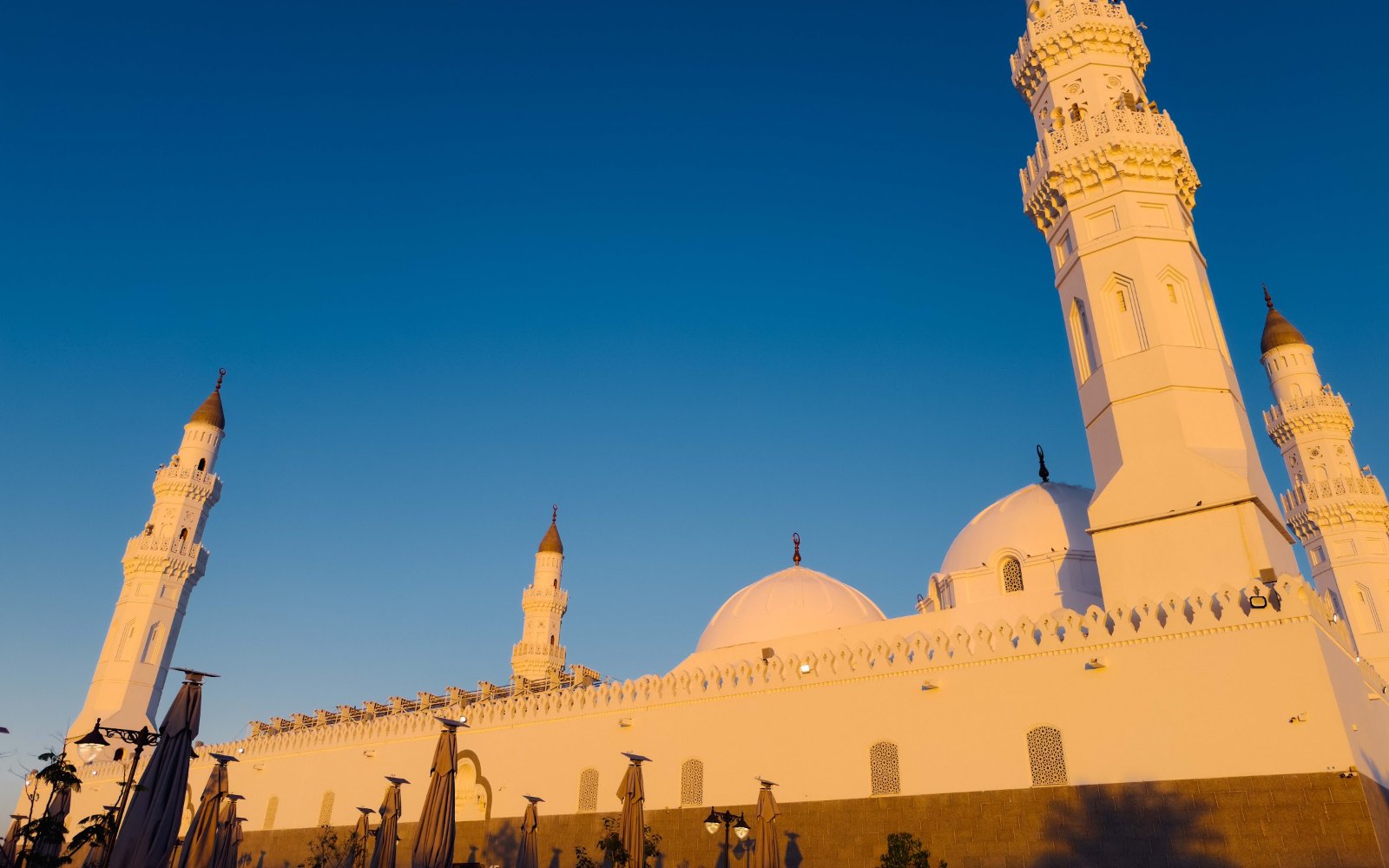 Masjid Quba di Madinah dengan menara putih dan kubah ketika senja