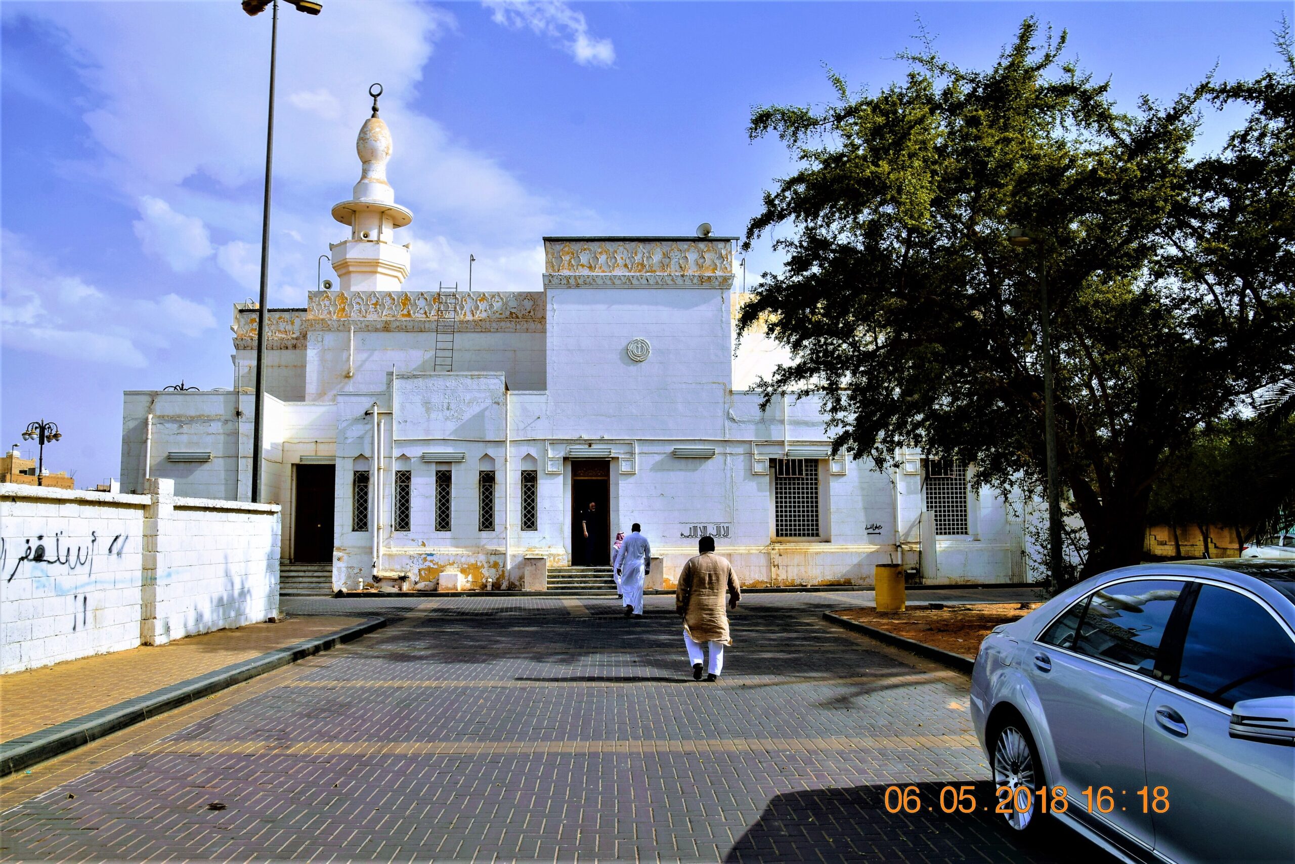 Bahagian hadapan Masjid at-Taubah di bandar lama Tabuk dengan menara putih dan dinding berhias geometri
