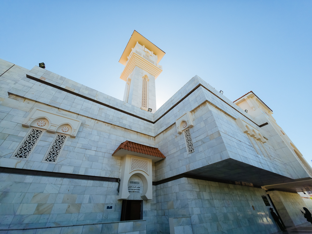 Menara bersegi dan dinding marmar putih Masjid M-30