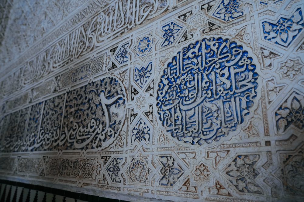 Ukiran kaligrafi Arab dan corak geometri pada dinding Alhambra, Granada